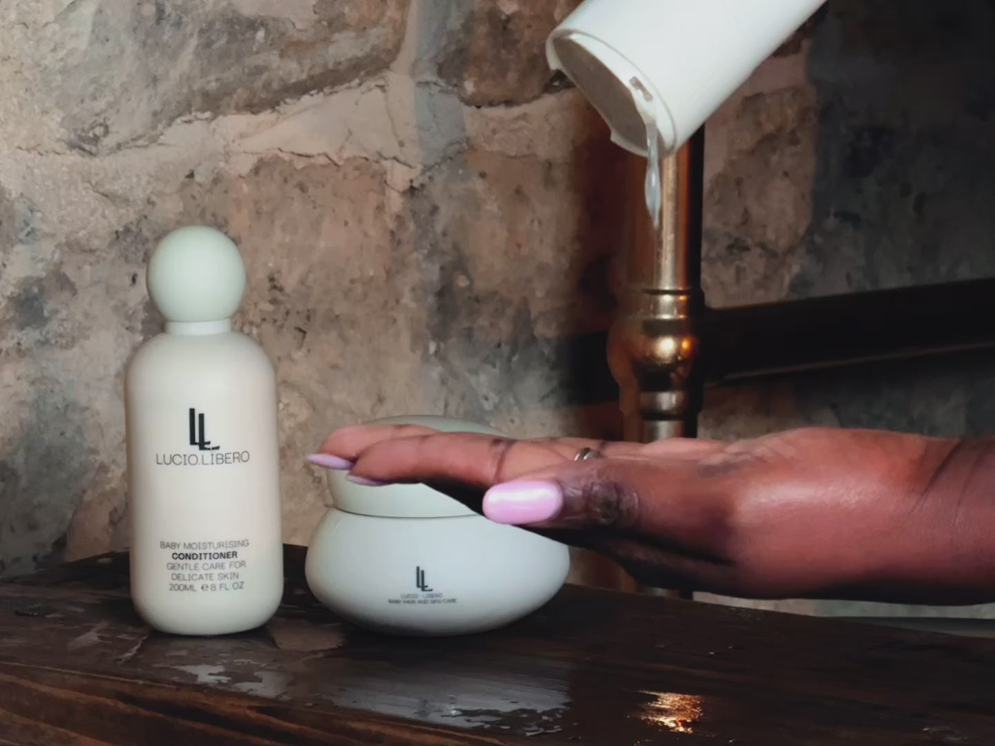 lucio libero shampoo & conditioner and balm in the bathroom being used to wash hair 